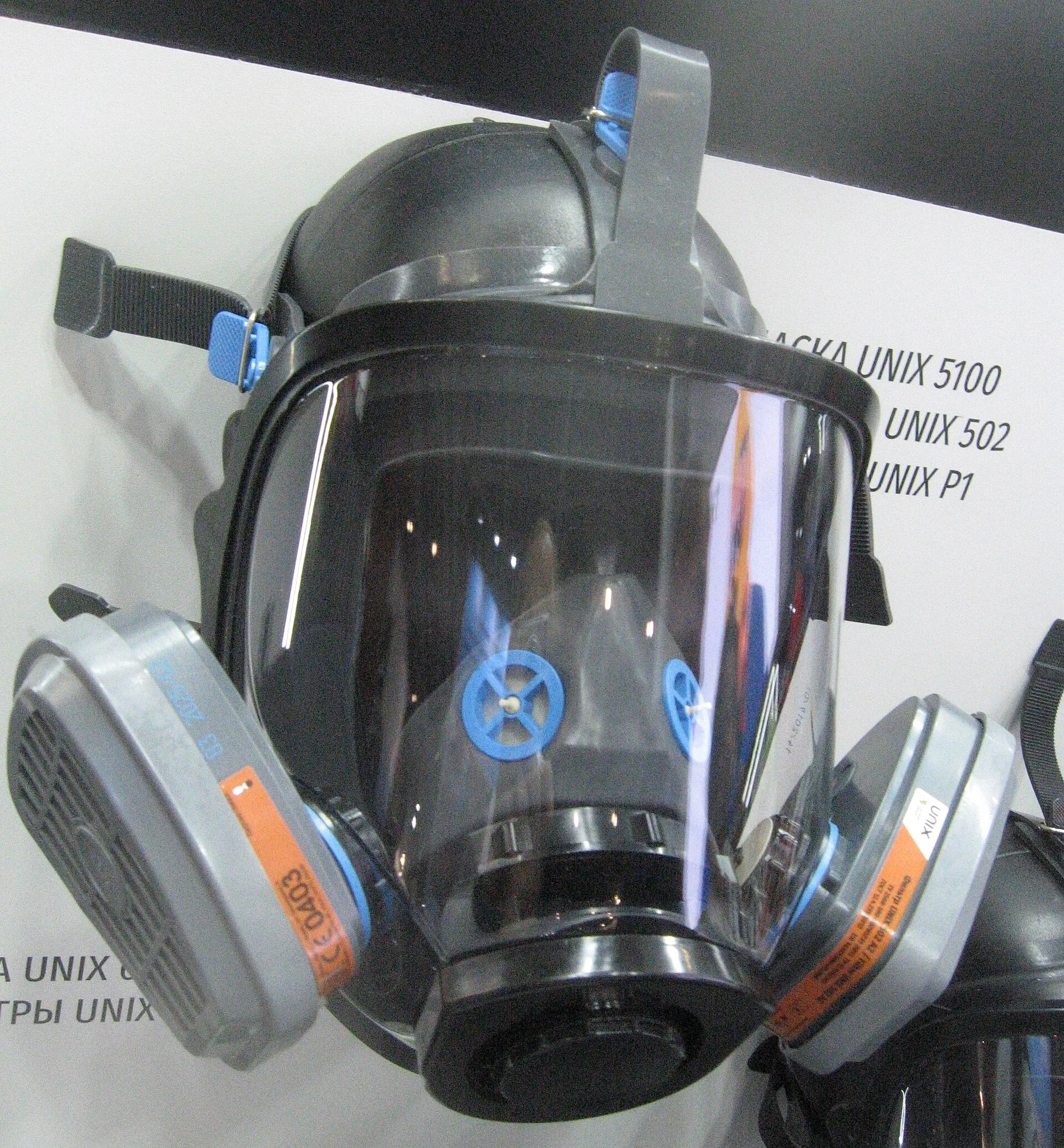 Full-face respirator with wide panoramic visor and twin gas filters on display