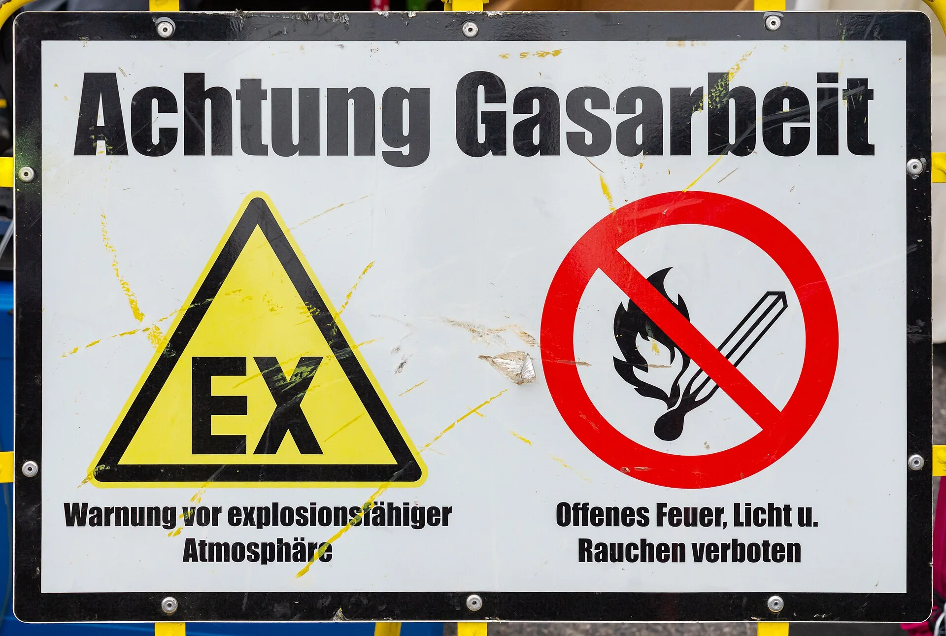 Gas works safety sign with yellow EX explosive atmosphere warning triangle and no-open-flame prohibition symbol