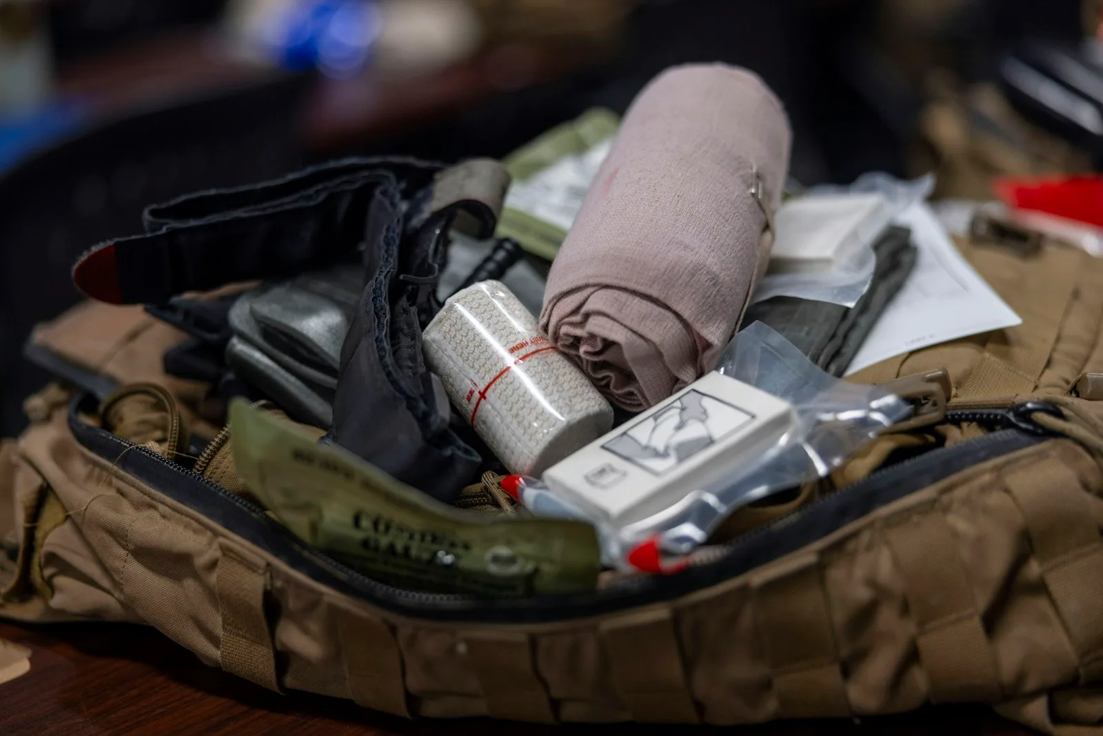 Tactical trauma kit bag with compression bandages and casualty care supplies